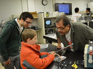 Reza Ghodssi and youngster visitor in lab